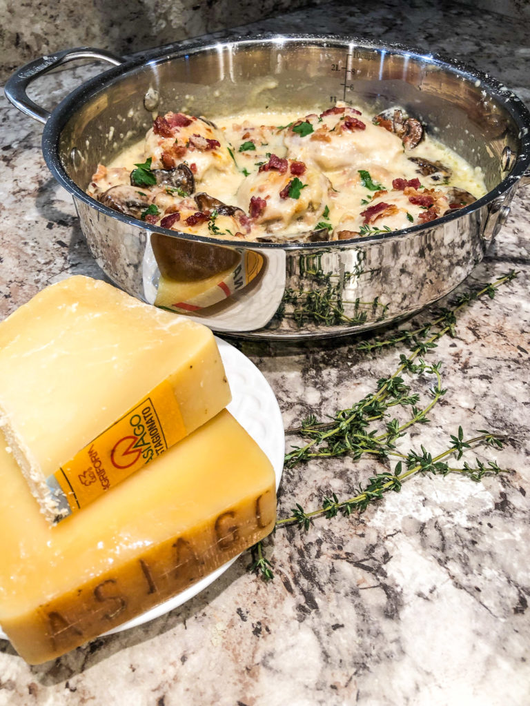 Nothing says winter to me more than a delicious, hearty meal. And when I think of "hearty," I instantly think of a rustic, cheesy dish that of course includes bacon! This rustic dish features chicken thighs in Asiago PDO bacon cream sauce.