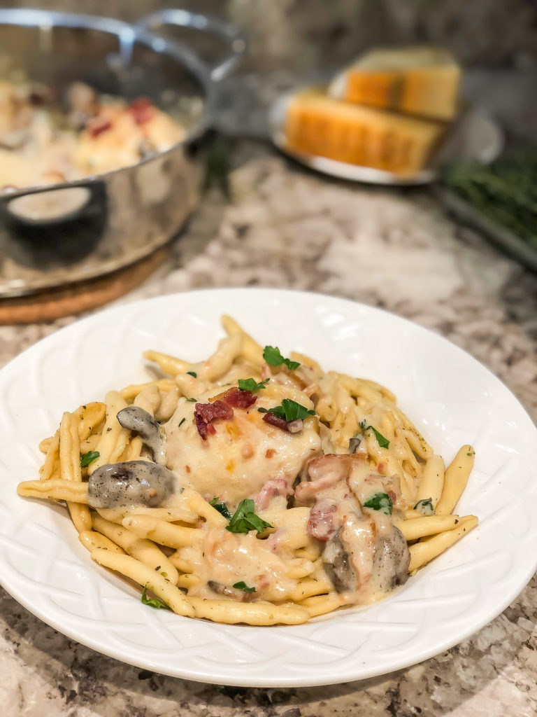 Nothing says winter to me more than a delicious, hearty meal. And when I think of "hearty," I instantly think of a rustic, cheesy dish that of course includes bacon! This rustic dish features chicken thighs in Asiago PDO bacon cream sauce.